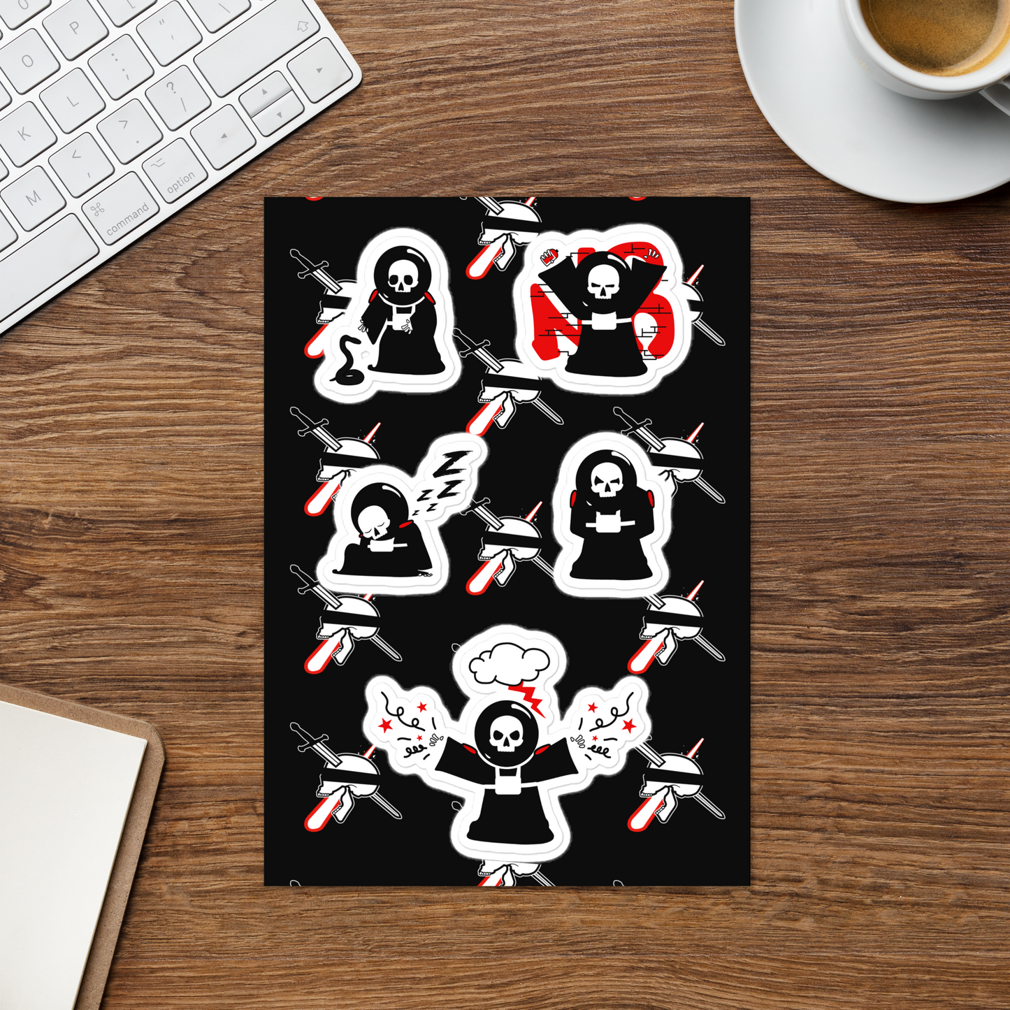 Sheet of stickers with neorebellion mascot character Rob illustrations on a black background on a wooden desk with a keyboard and coffee cup.
