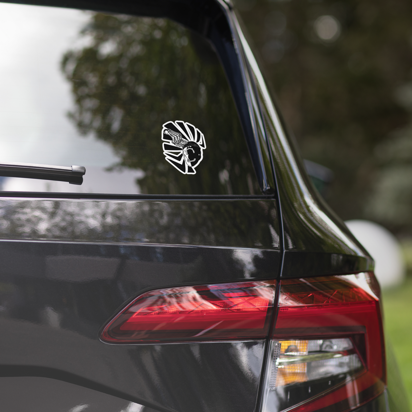 Car sticker on a car's rear window with a blurred outdoor background