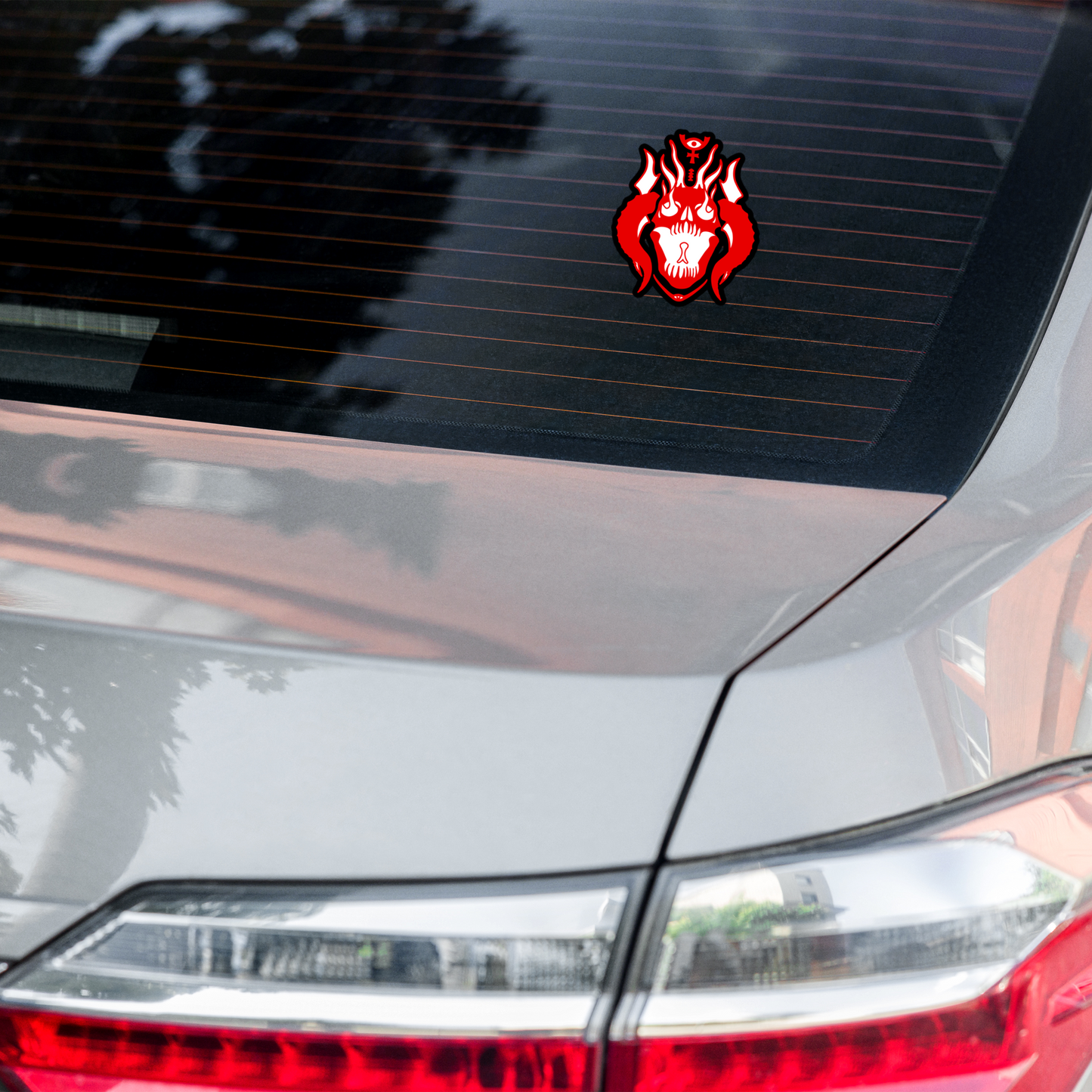 Car with a red and black decal on the rear window