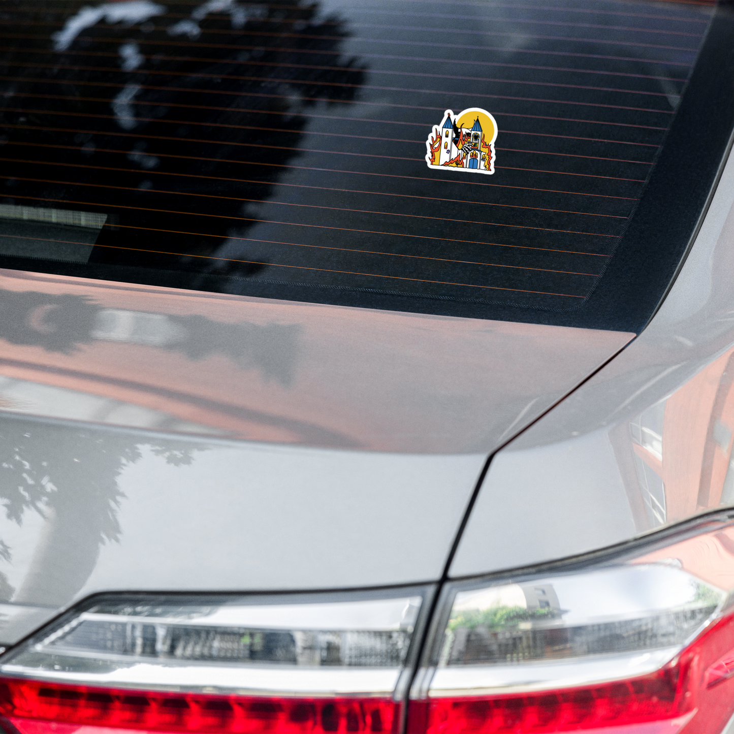 Car sticker on a car's rear window with a colorful design.
