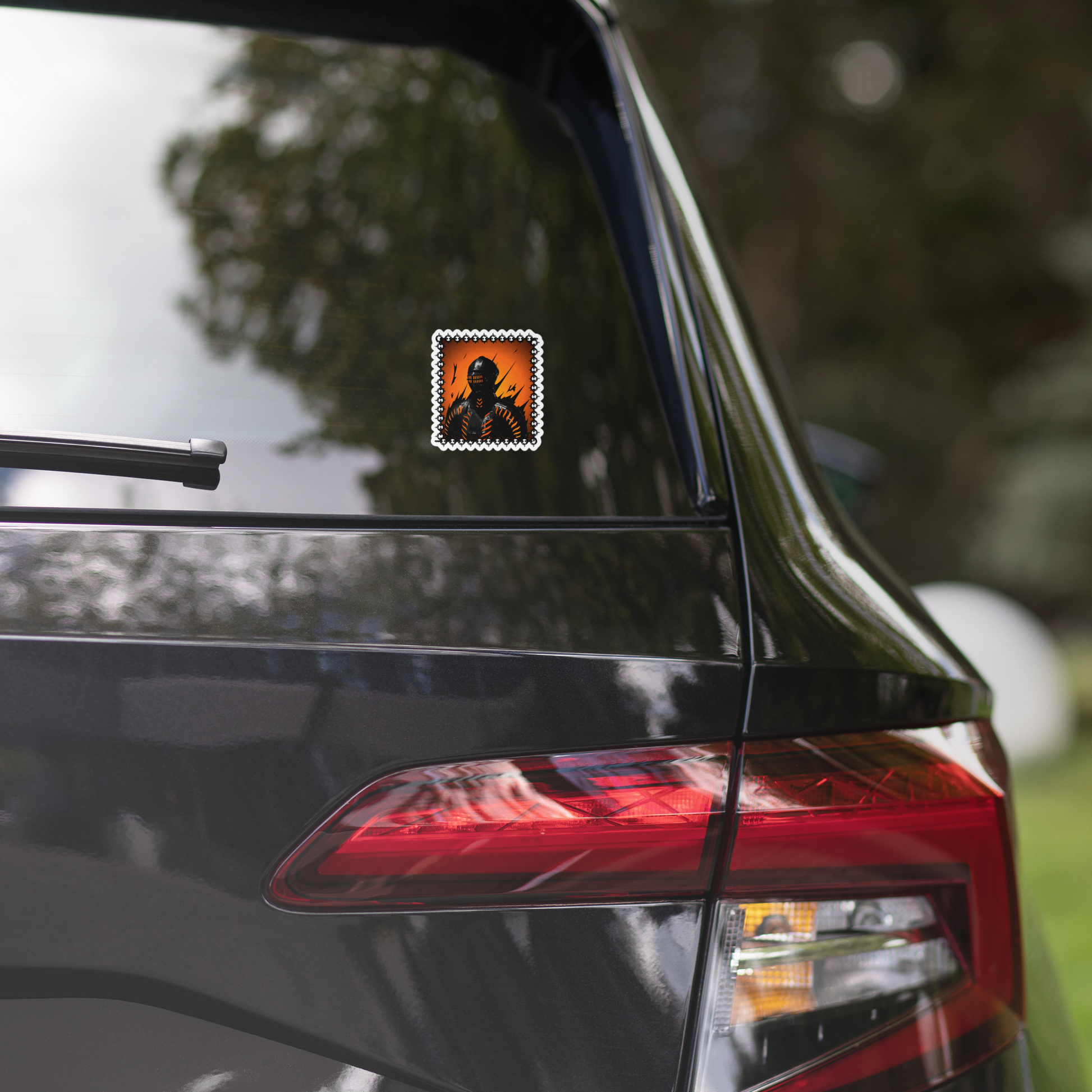 Car with a sticker of a knight with an orange background on the rear window, blurred background