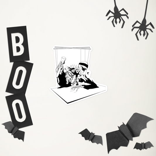 A sticker of a black and white heavy metal style skeleton figure with a blindfold holding a gavel, sitting on a chair with a table in front, in front of Halloween-themed decorations including 'BOO' letters, spider webs, and bat shapes on a white background.