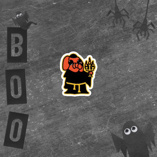 Halloween-themed sticker of an orange cartoon dog, black robe, and holding a candelabra on a white background with a ghost and 'BOO' text on a textured black background
