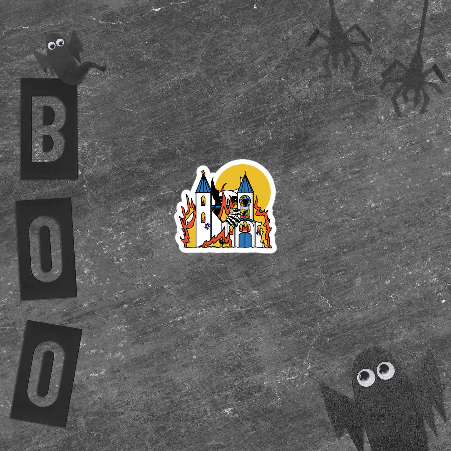 Halloween-themed sticker with a colorful illustration of a giant monster attacking a flaming church full of teddy bears on a textured gray background with 'BOO' letters and ghost figures.