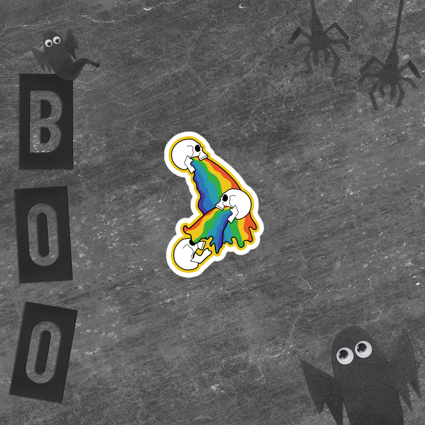 Colorful rainbow skull vomit sticker on a gray background with 'BOO' letters and black ghosts.