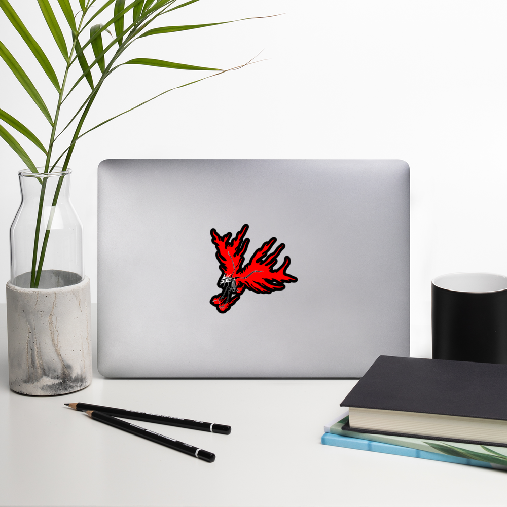 Laptop with a red skeletal eagle decal on a white surface with a plant, pencils, and books.