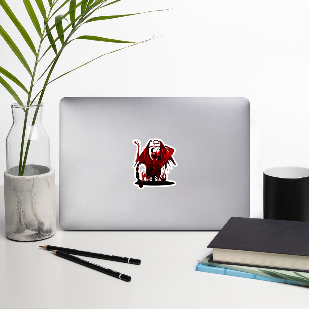Laptop with a red skeletal demon sticker on a desk with a plant, pencils, and books.