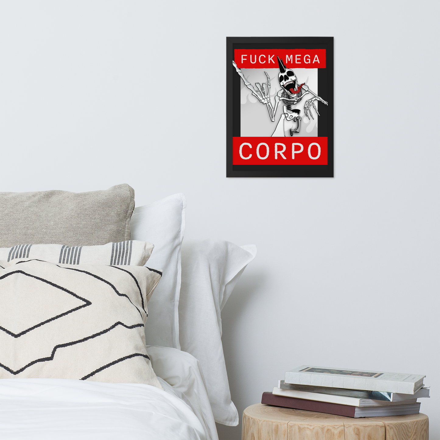 Framed artwork of a heavy metal skeleton in front of 'FUCK MEGA CORPO' text with red, white, black, and grey coloration, on a wall above a bed.