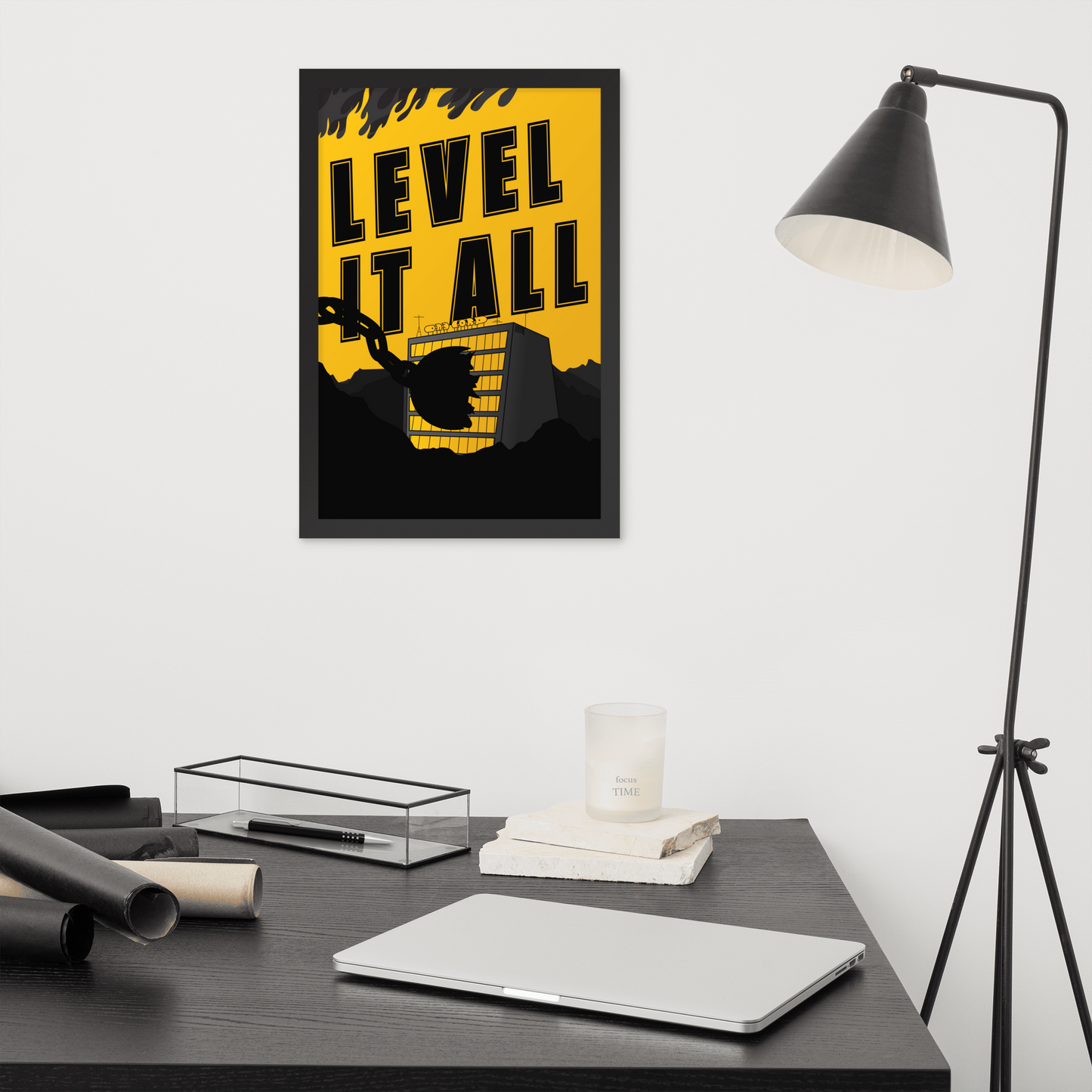 Framed poster with 'Level It All' design above a desk with office supplies.