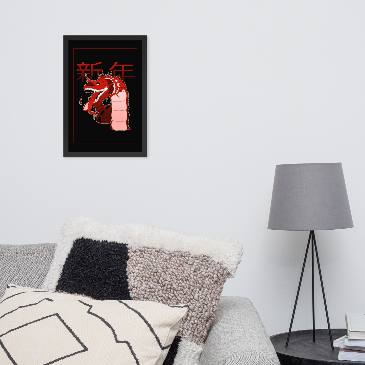 A red dragon poster with chinese characters and a black background hanging over a couch next to a lamp