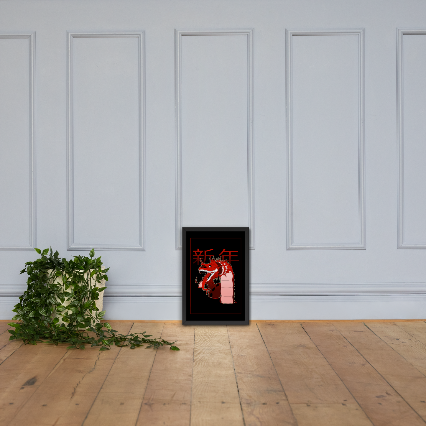 Framed artwork with red and white design on a white wall with wooden floor