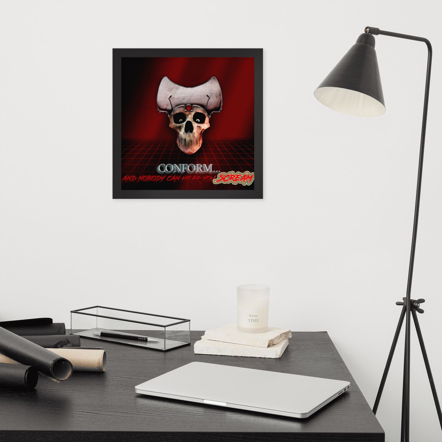 Large framed poster with a heavy metal skull design on a desk with a lamp and decor items.