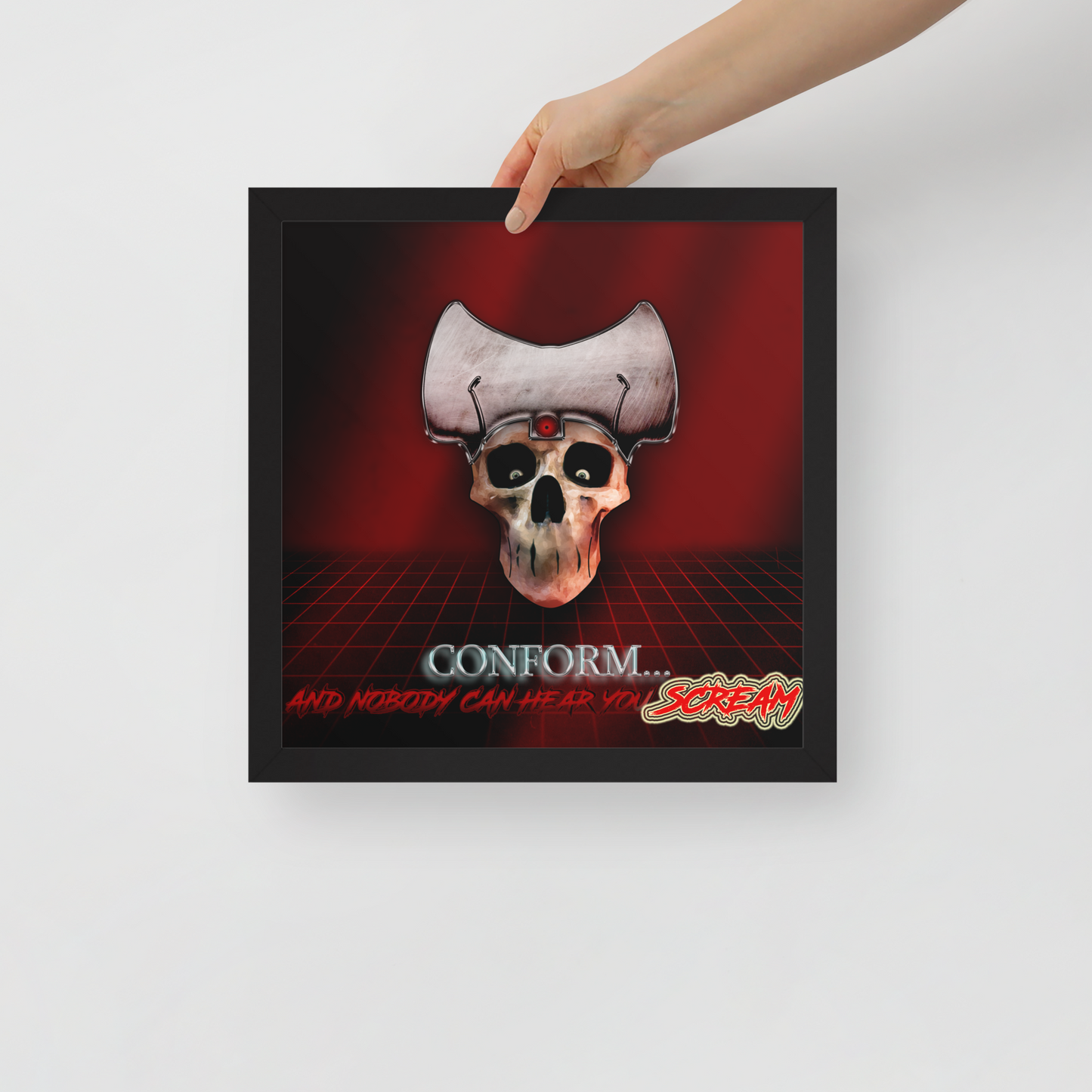 Framed artwork with a skull design and text on a red background, held by a hand.