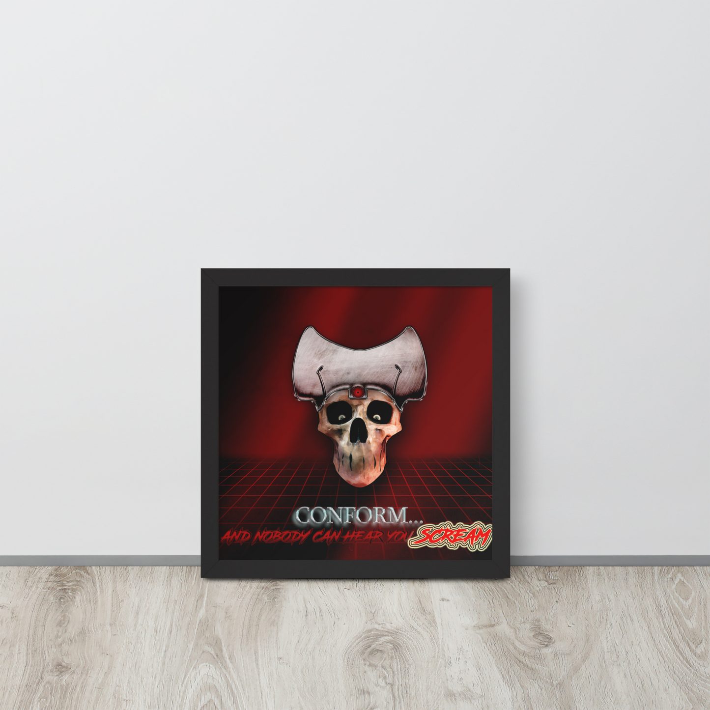 Framed red artwork with a skull and text on a red background, displayed on a light wooden floor.