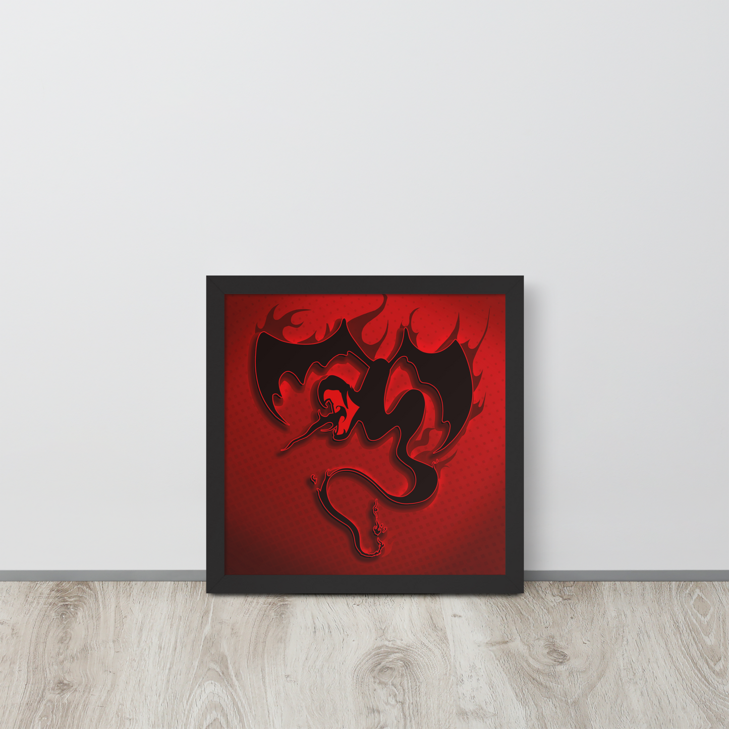 Framed artwork of a black winged snake dragon on a red background against a white wall.