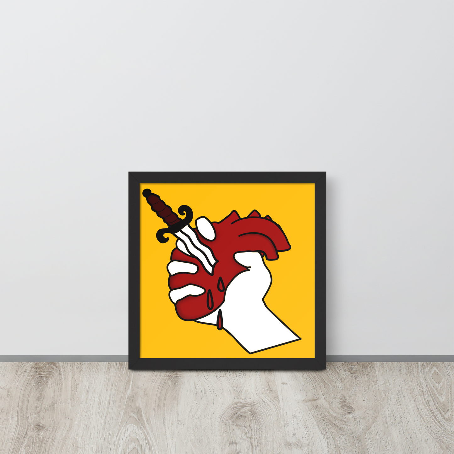 Framed artwork with a stylized tattoo illustration of a hand holding a heart with a twisted dagger on a yellow background.