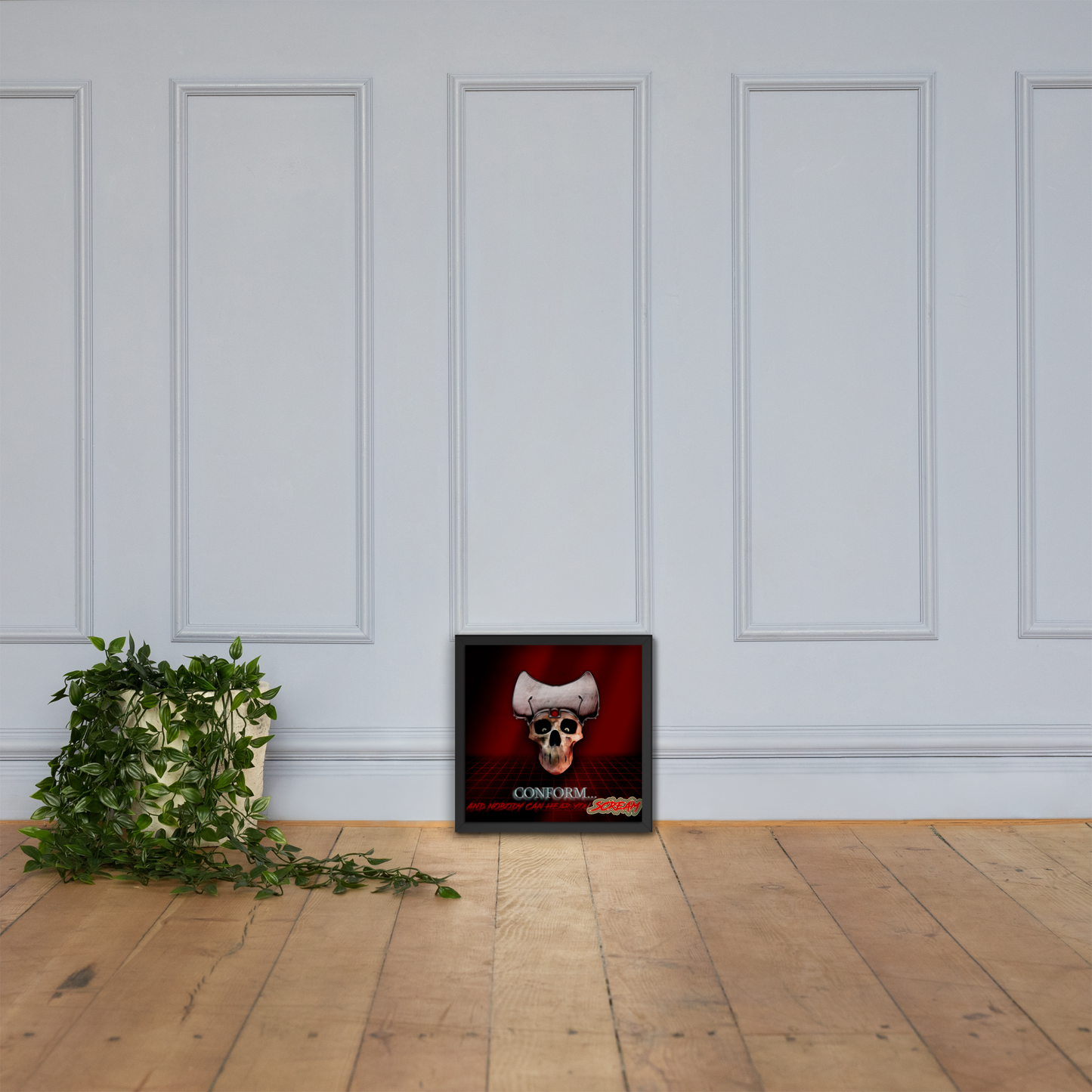 Framed artwork with a skull design on a white paneled wall.