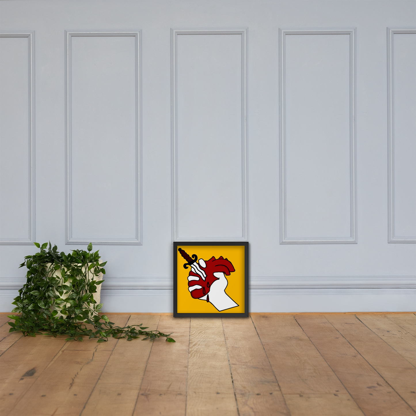 Framed heart tattoo artwork on a frame dposter on a wooden floor with a white paneled wall background