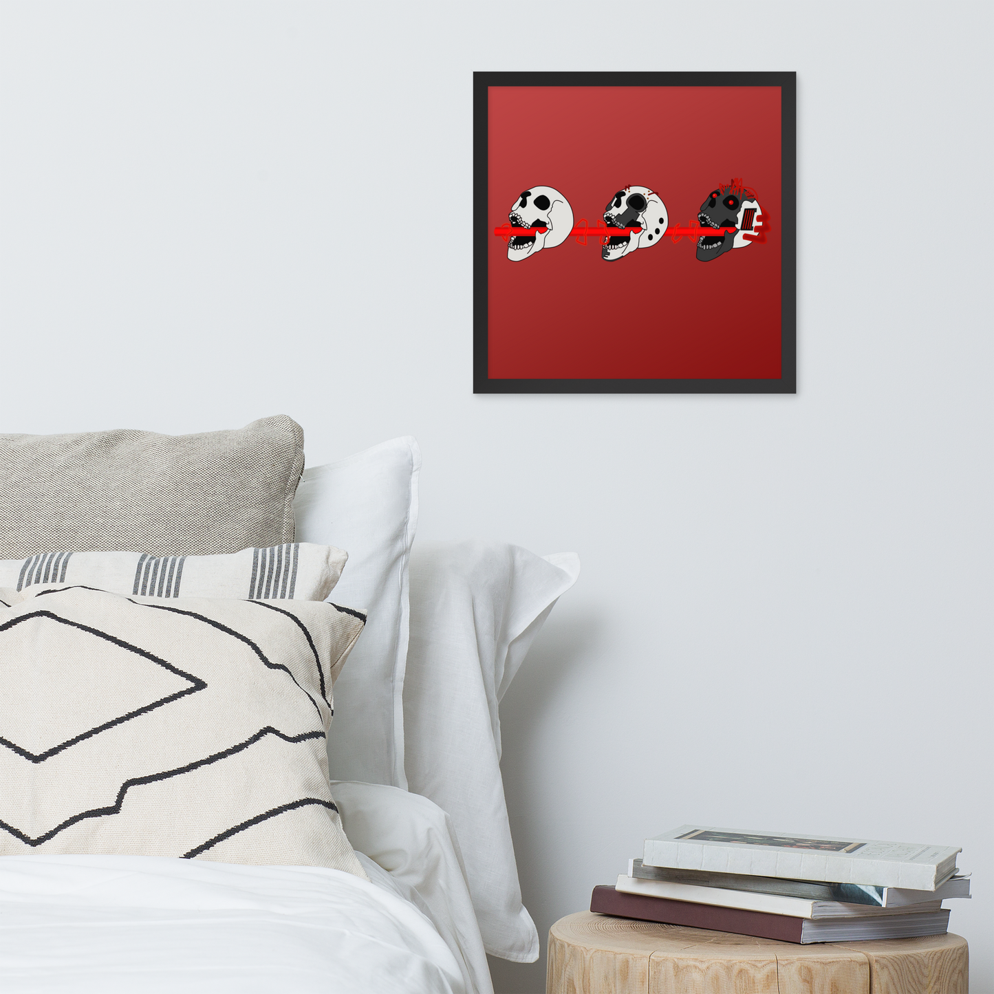 Framed poster of three skulls shooting a laser through their mouths in a cyberpunk style on a red gradient background artwork on a wall above a bed.
