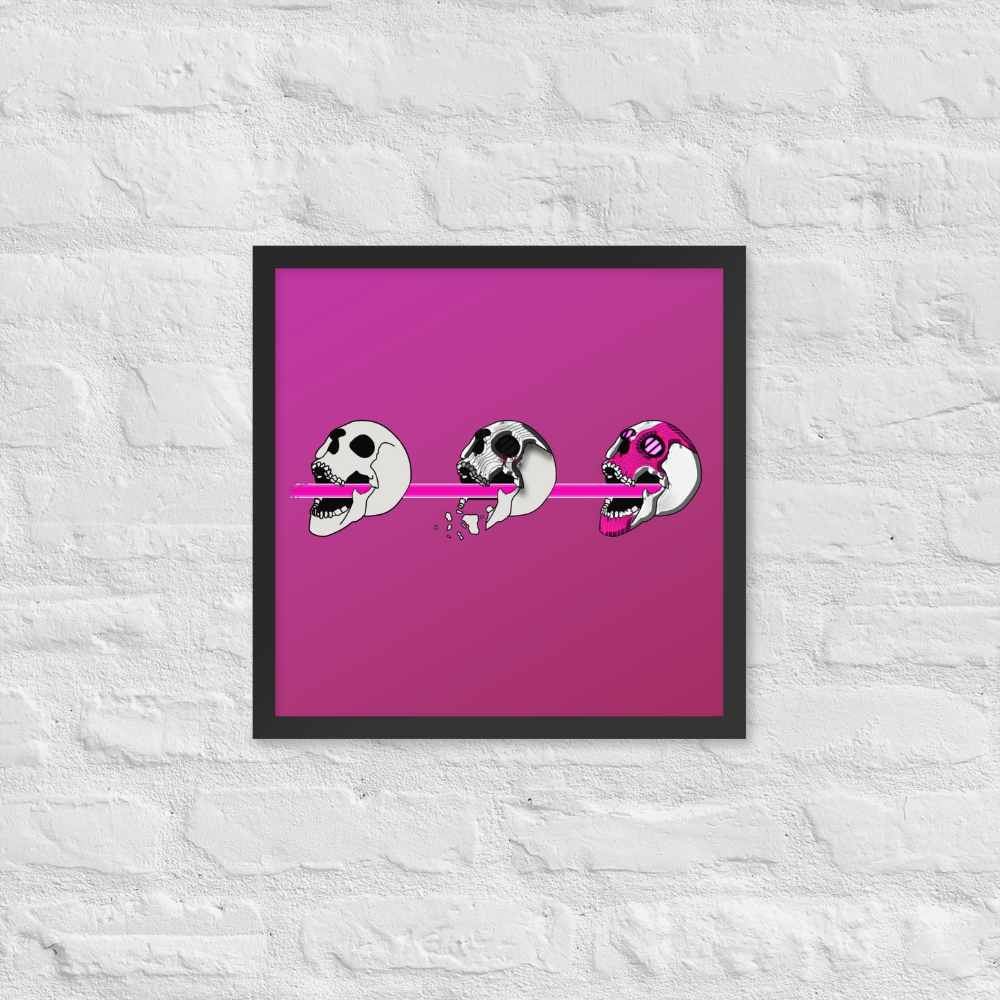 Framed artwork with three stylized skulls on a pink background against a textured white wall.