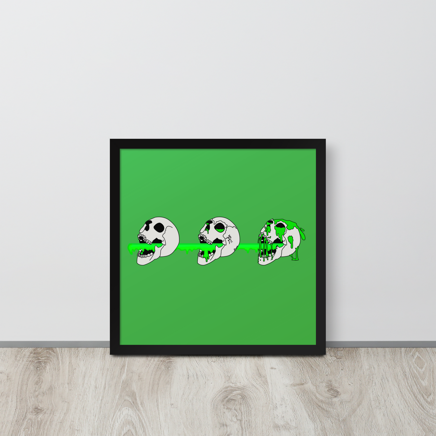 Framed artwork with a green background and black frame on a light wooden floor.