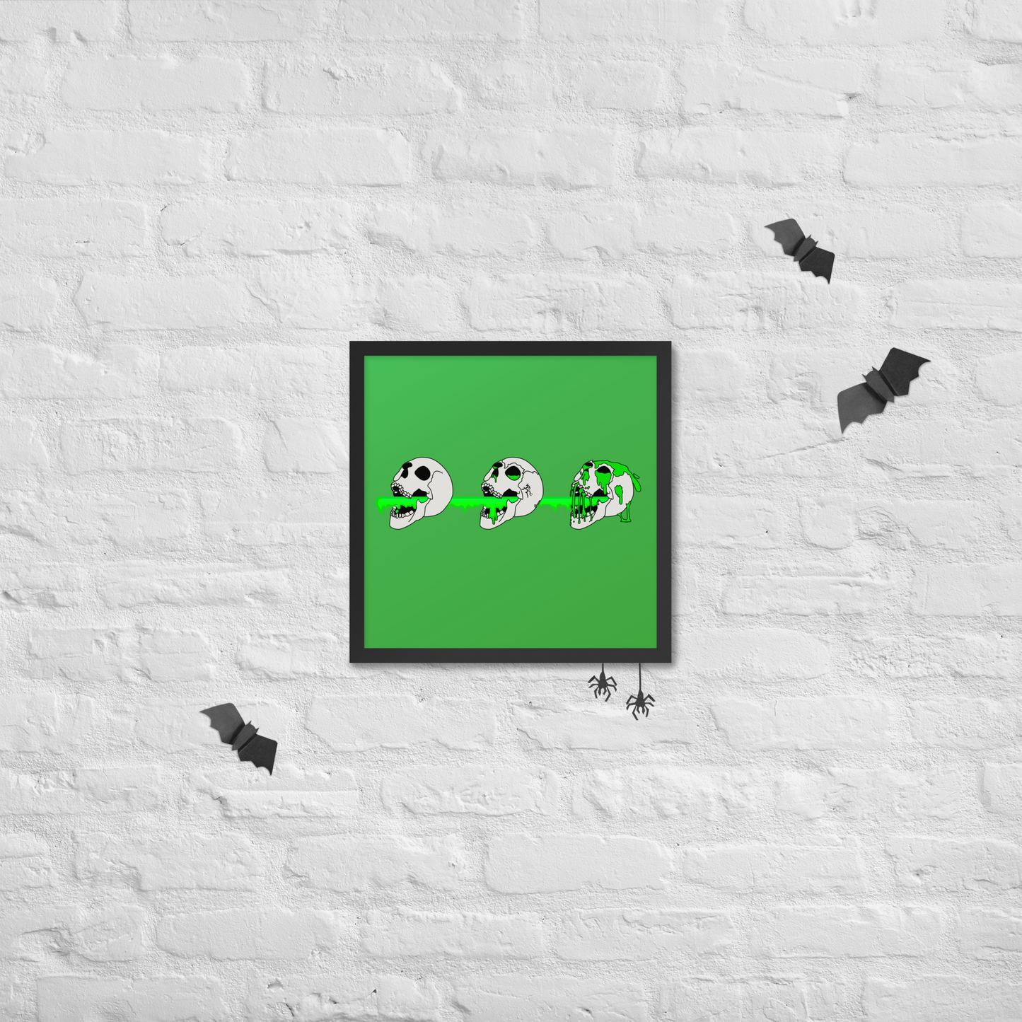 Framed artwork of 3 skulls shooting green slime from their mouths with a gradient background in a horror style, hanging on a textured halloween white wall.