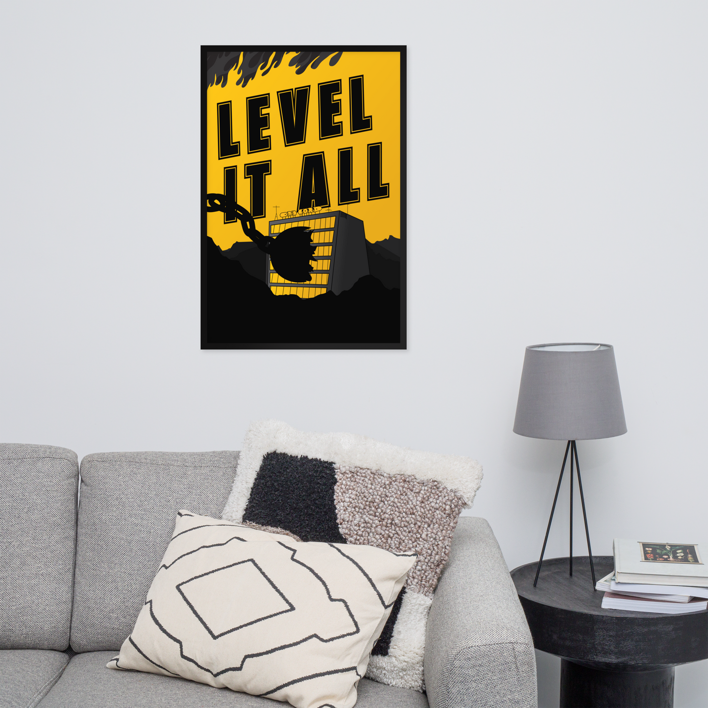 Poster with 'Level It All' text on a wall above a gray sofa with decorative pillows.