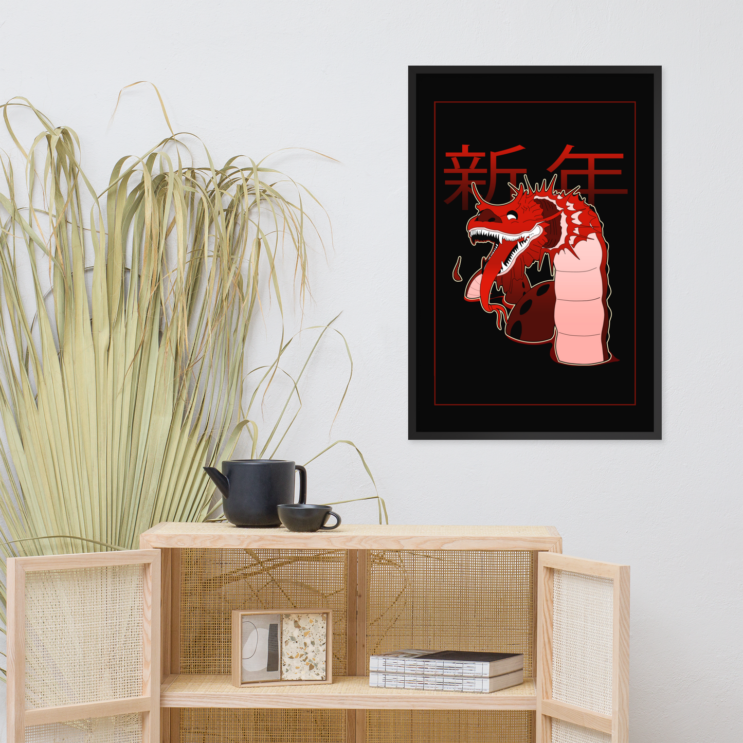 Framed artwork with a red dragon design on a wall above a wooden cabinet.
