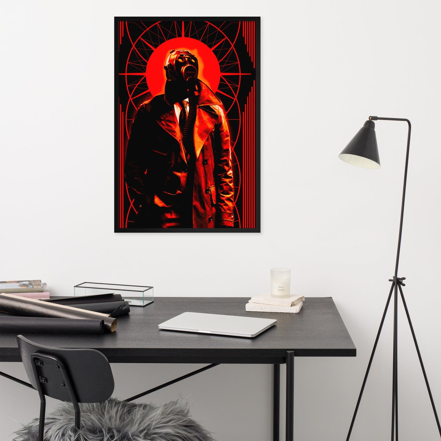 Framed 24x36 artwork of a stylized, art-deco style illustration in orange, black, and white tones, with a mysterious figure in a gas mask and a trench coat in the center on a wall above a desk with office supplies.