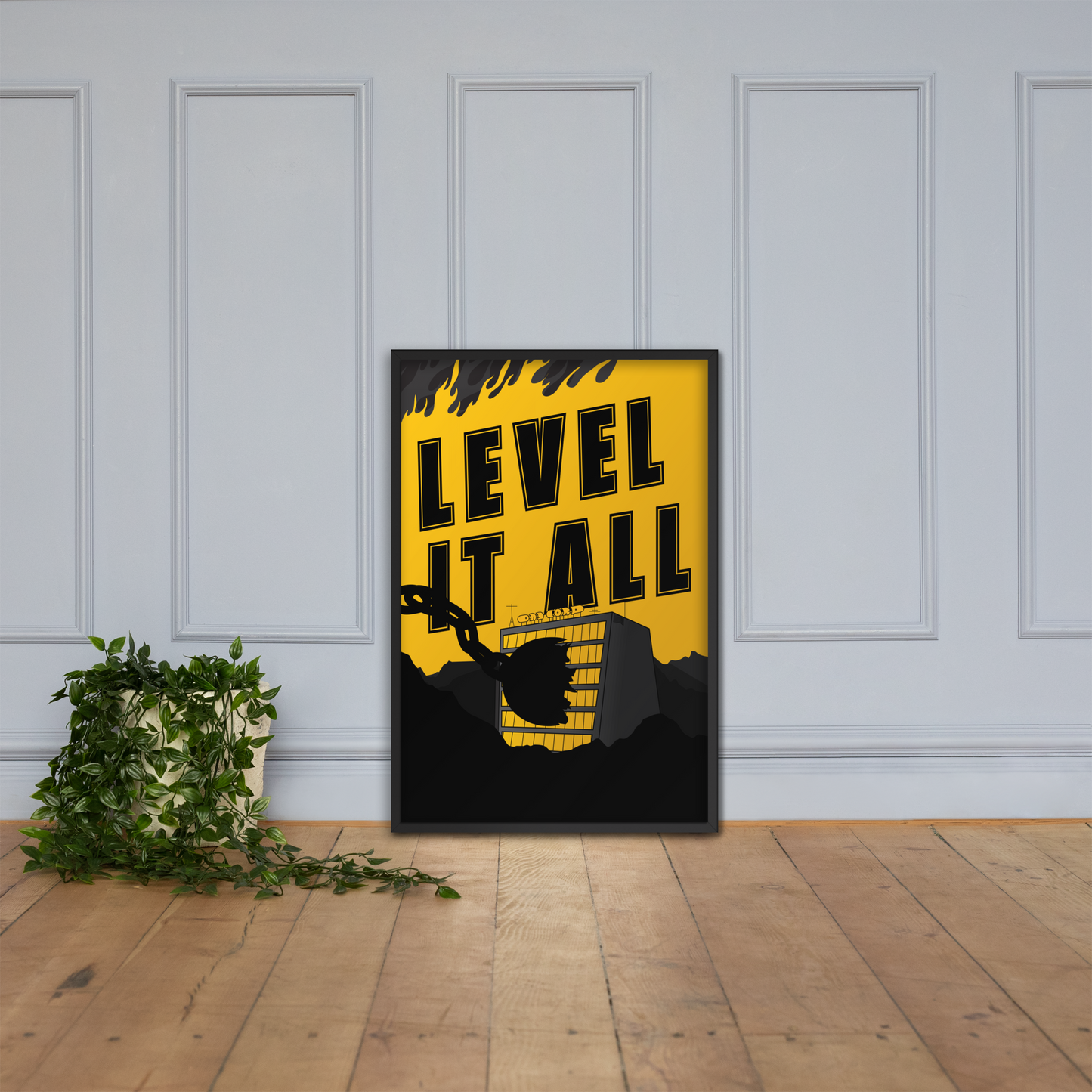 Framed poster with 'LEVEL IT ALL' text on a yellow background, leaning against a white paneled wall.