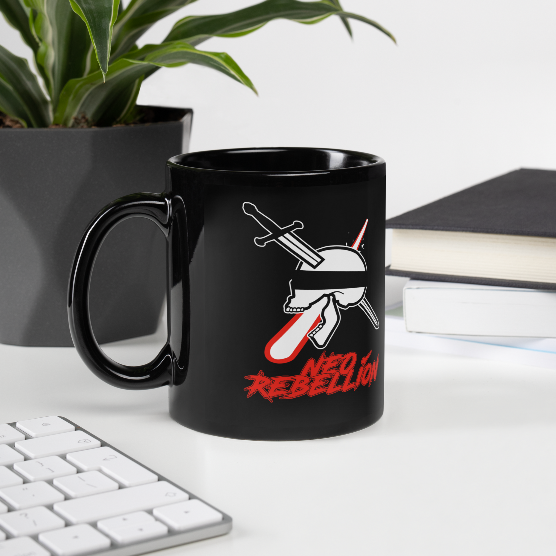 Black mug with a graphic design featuring a skull and crossed swords on a desk with a plant and books in the background.