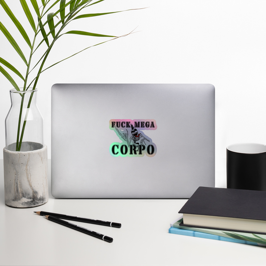 Laptop with a sticker on a desk with a plant, mug, and books.