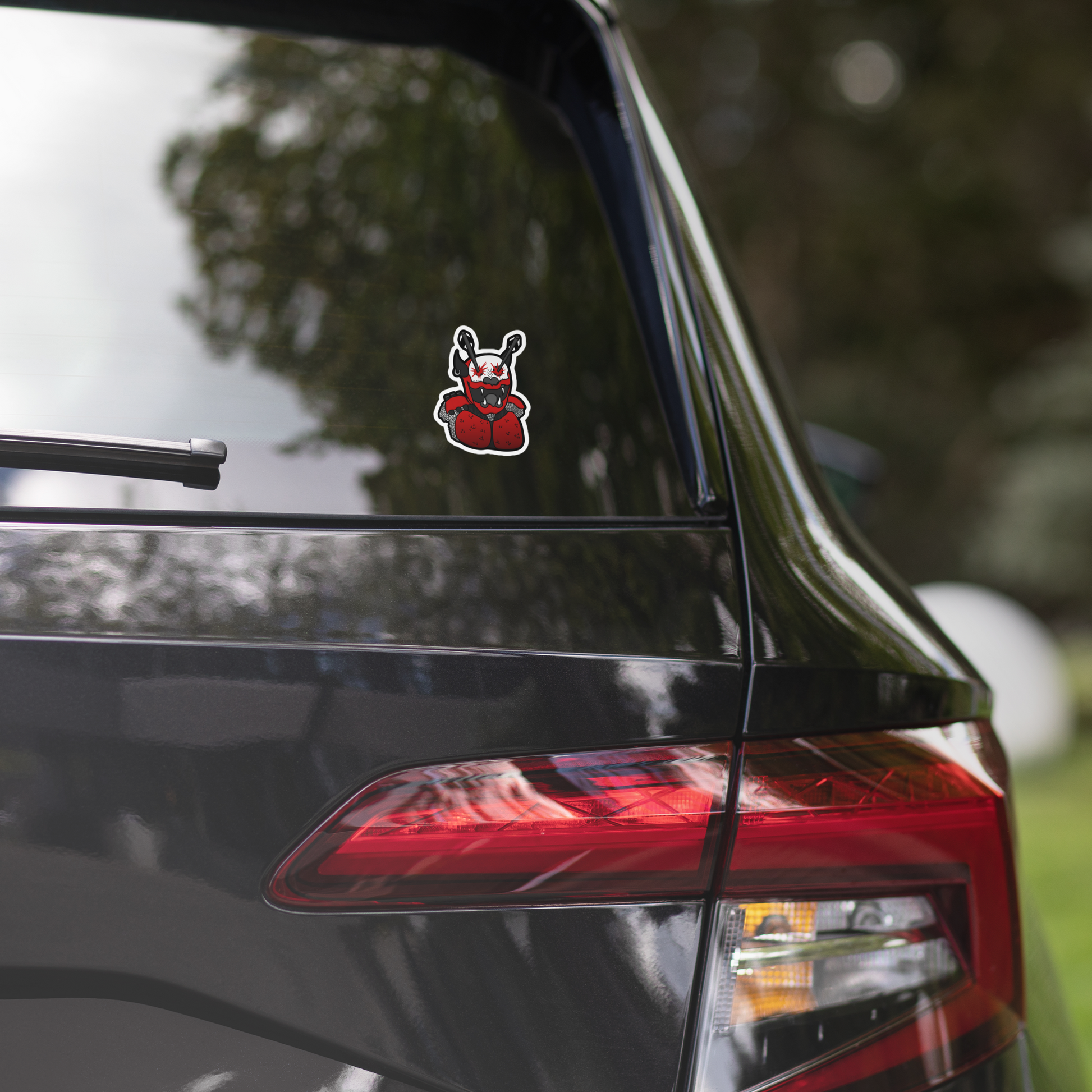 Car with a decal on the rear window, featuring a hand print with a red heart.