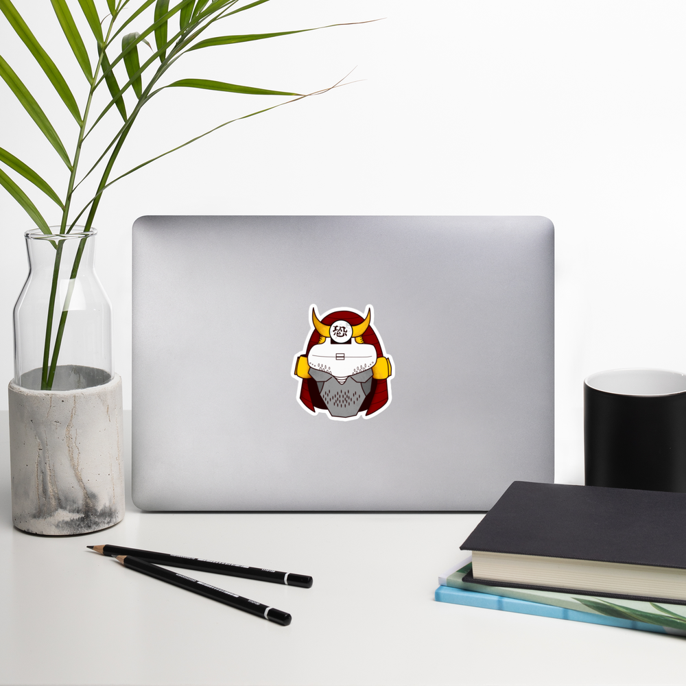 Laptop with a cyberpunk samurai helmet sticker on a desk with a plant, pencils, and books.