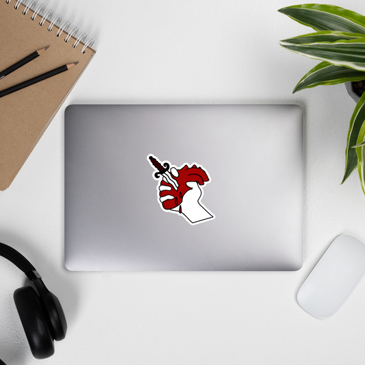Laptop with a sticker on a desk with a notebook, pencils, headphones, and a plant.