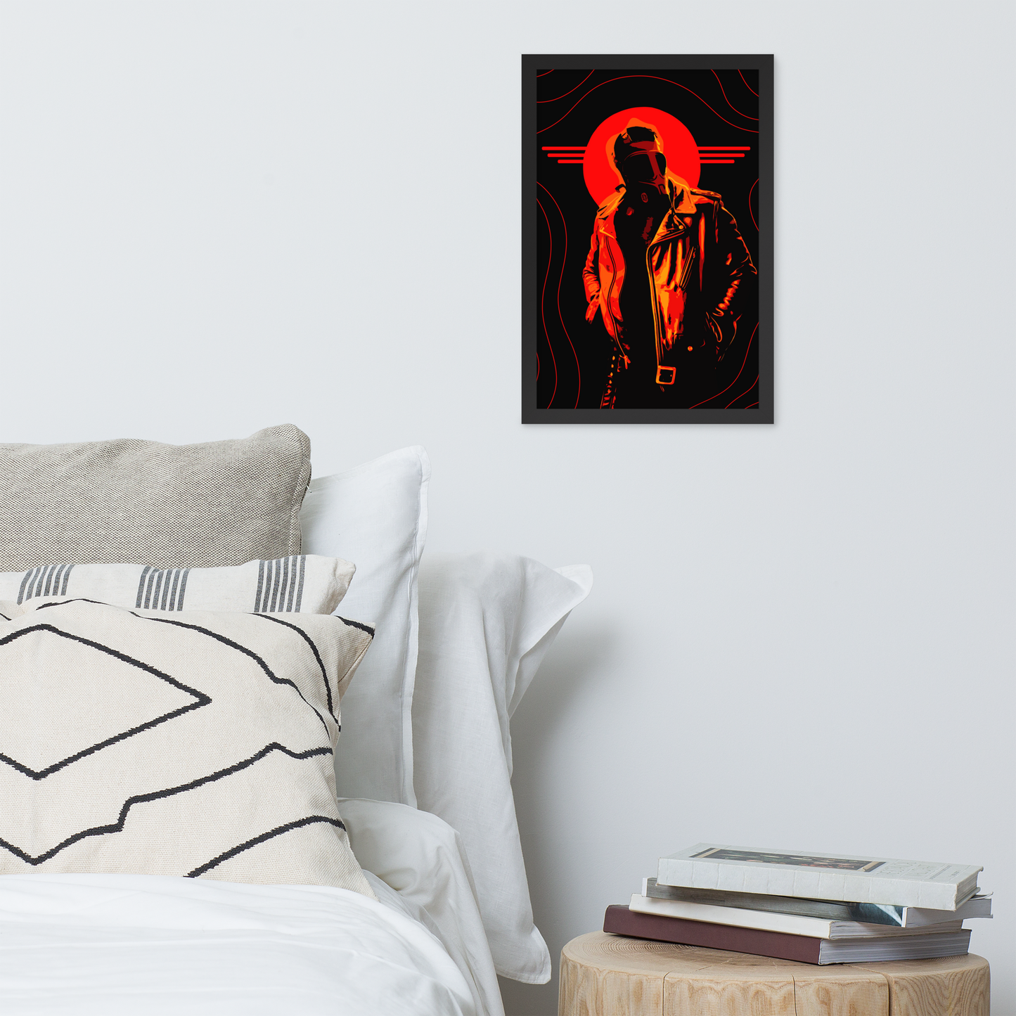 Framed artwork of a mysterious figure in a gas mask in front of an orange circle and wavy lines above a bed.