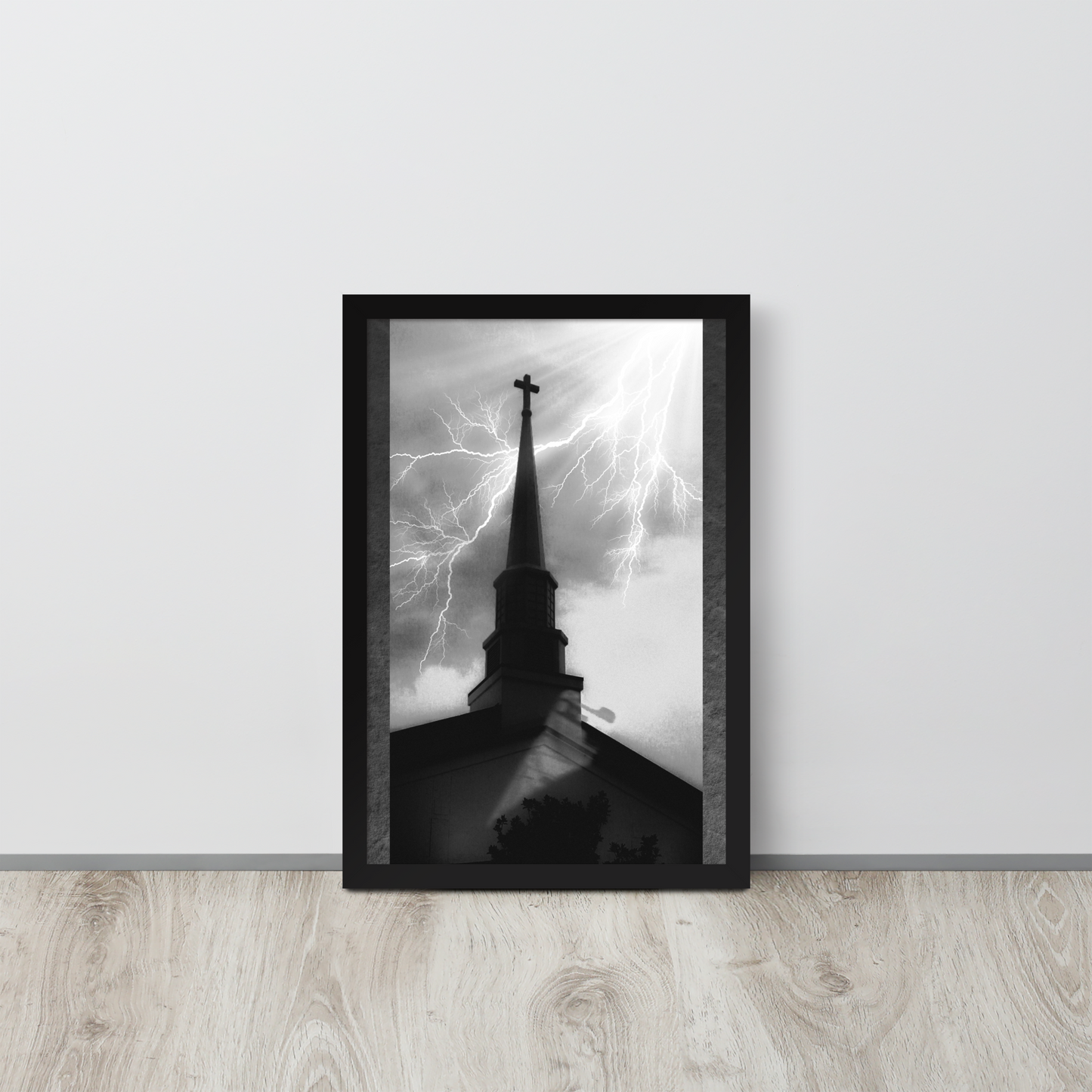 12x18 poster of a shadowy church in front of a lightning strike in grainy black and white heavy metal style leaning on a white wall