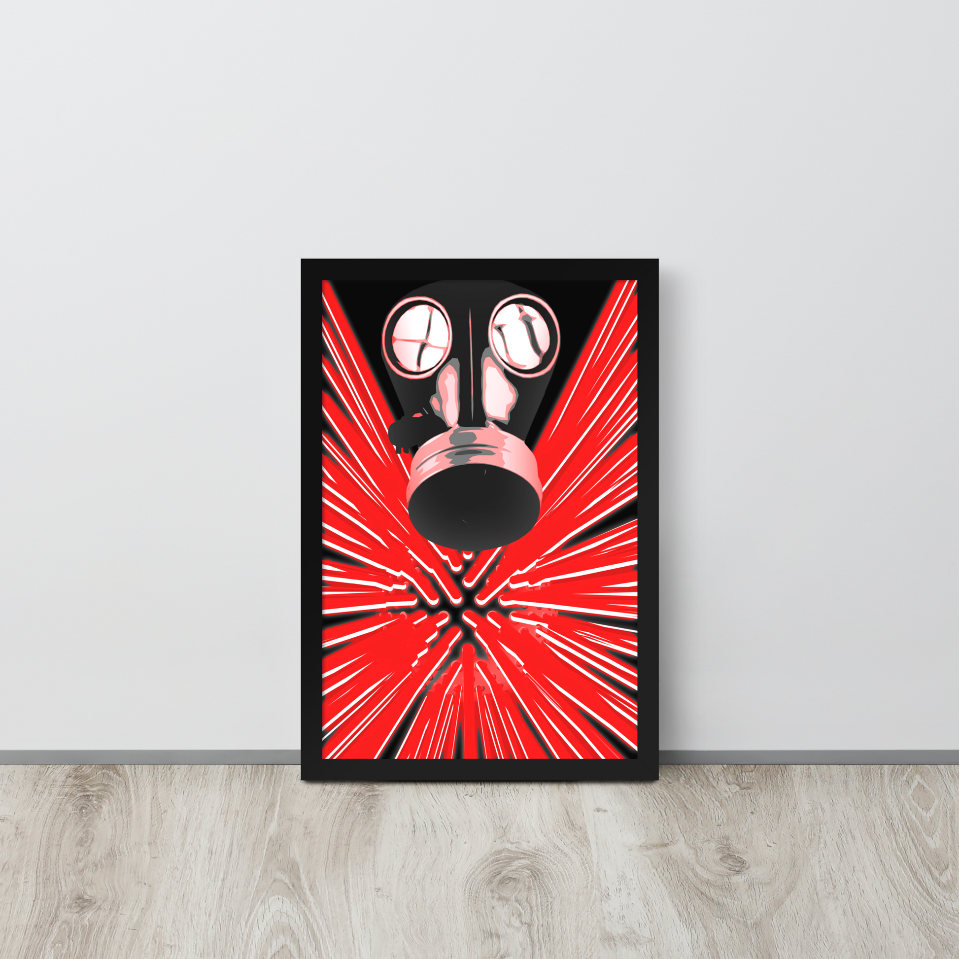 A framed art print leaning against a light gray wall on a light wood floor. The print features a stylized black gas mask centered over a bright red burst pattern with black radiating lines.