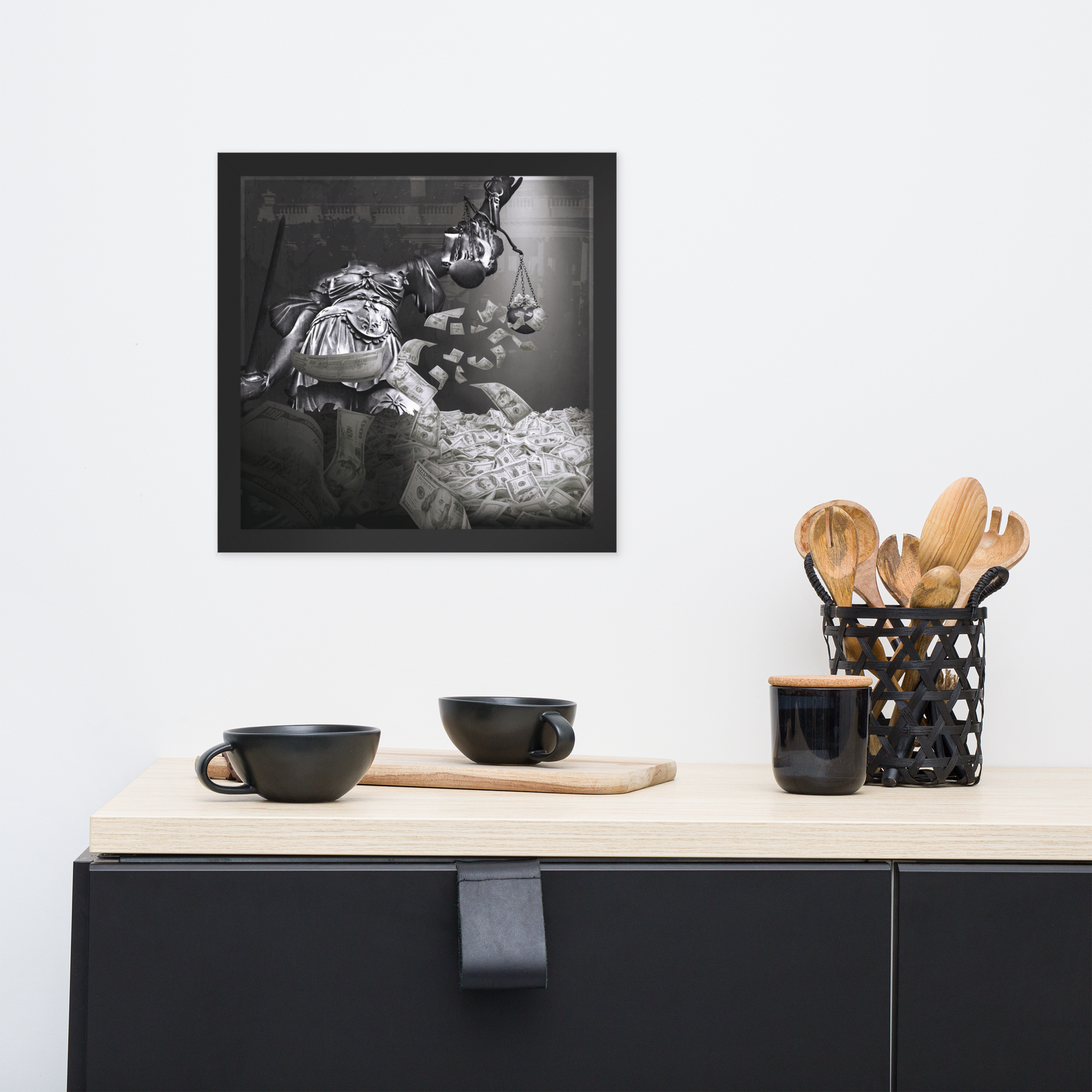 Framed black and white artwork on a wall above a kitchen counter with utensils.