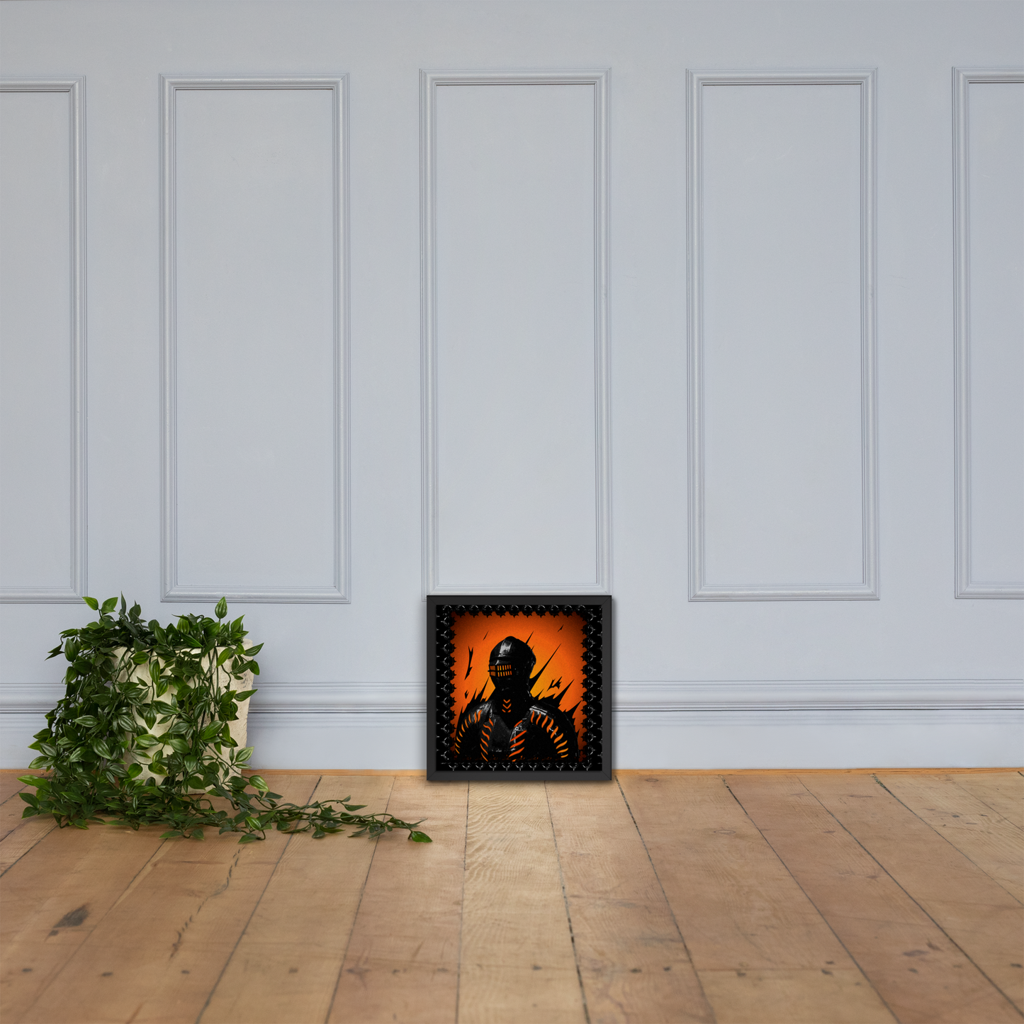 Framed artwork of a knight's silhouette against an orange background on a white paneled wall.