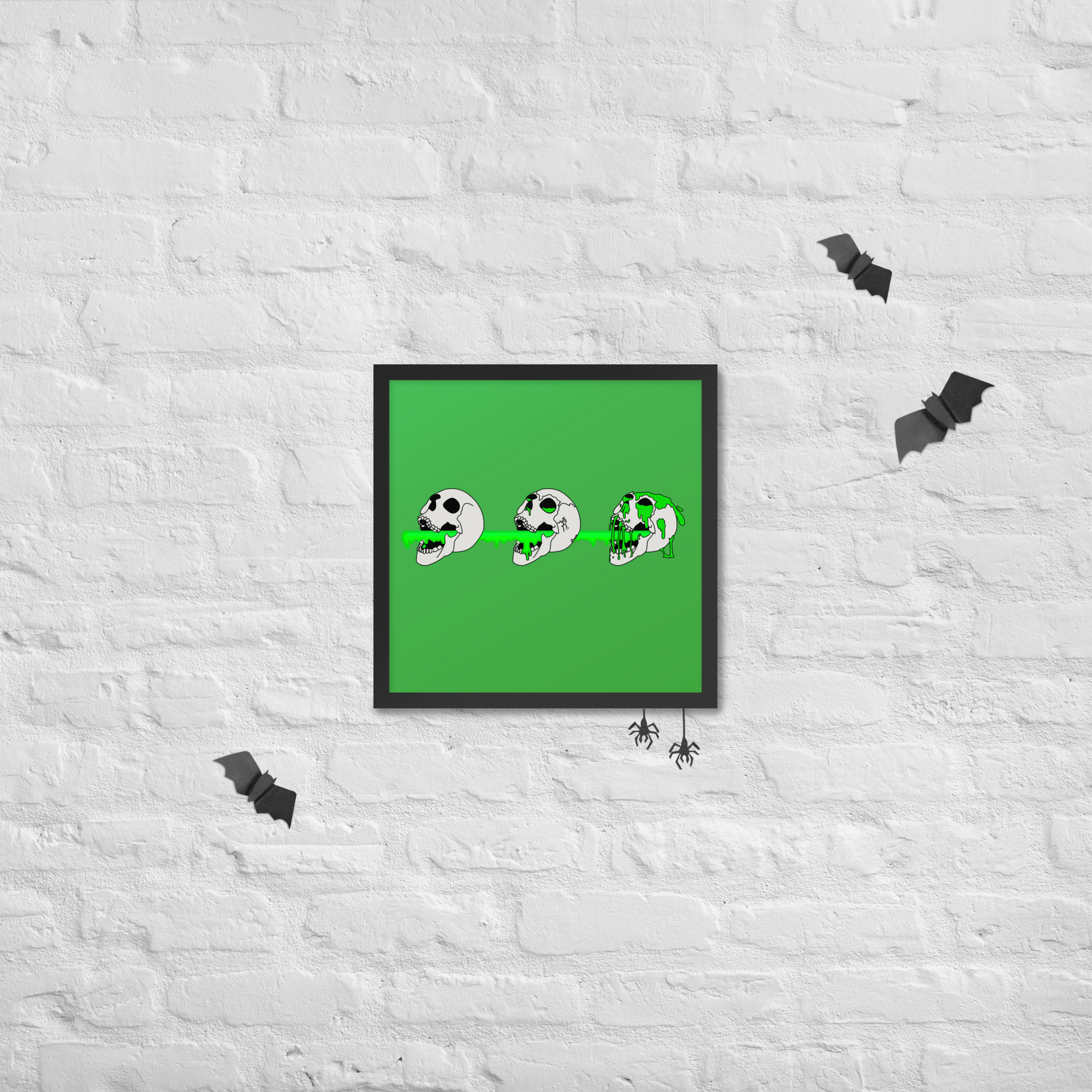 Framed artwork of 3 skulls shooting green slime from their mouths with a gradient background in a horror style, hanging on a textured halloween white wall.