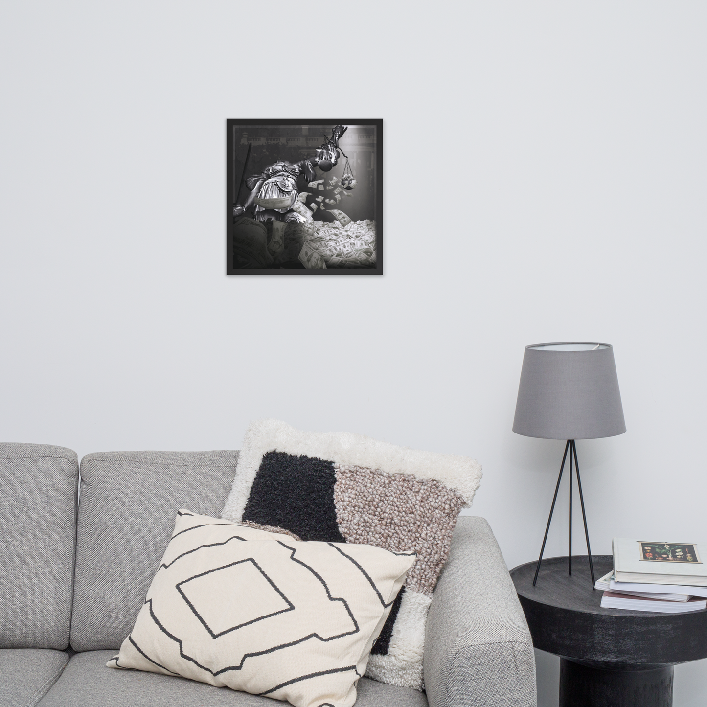 Living room with gray sofa, decorative pillows, and a framed black and white photo on the wall.