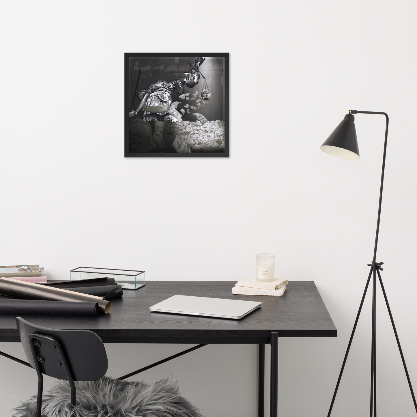 Modern office setup with a black desk, chair, and lamp against a white wall.
