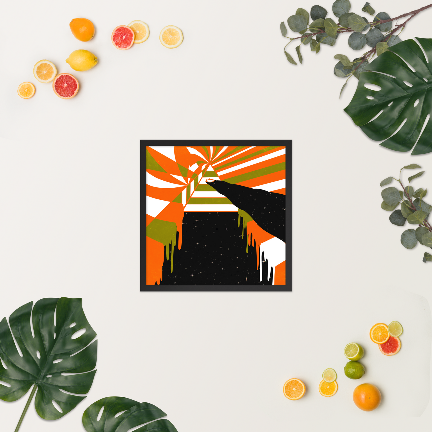 Framed abstract artwork with colorful design on a white background, surrounded by fruits and leaves.