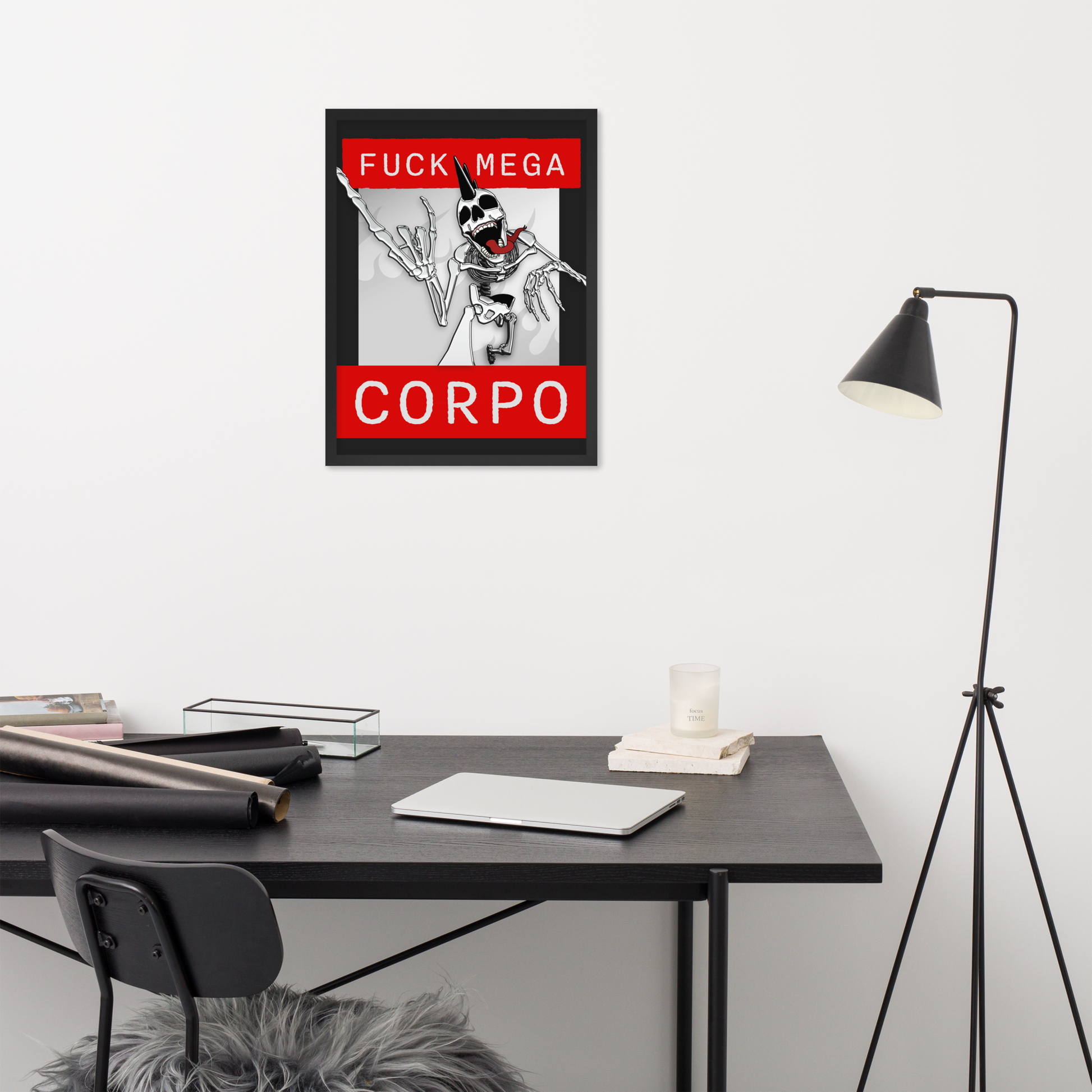 Framed 18x24 artwork of a heavy metal skeleton in front of 'FUCK MEGA CORPO' text with red, white, black, and grey coloration on a wall above a desk.