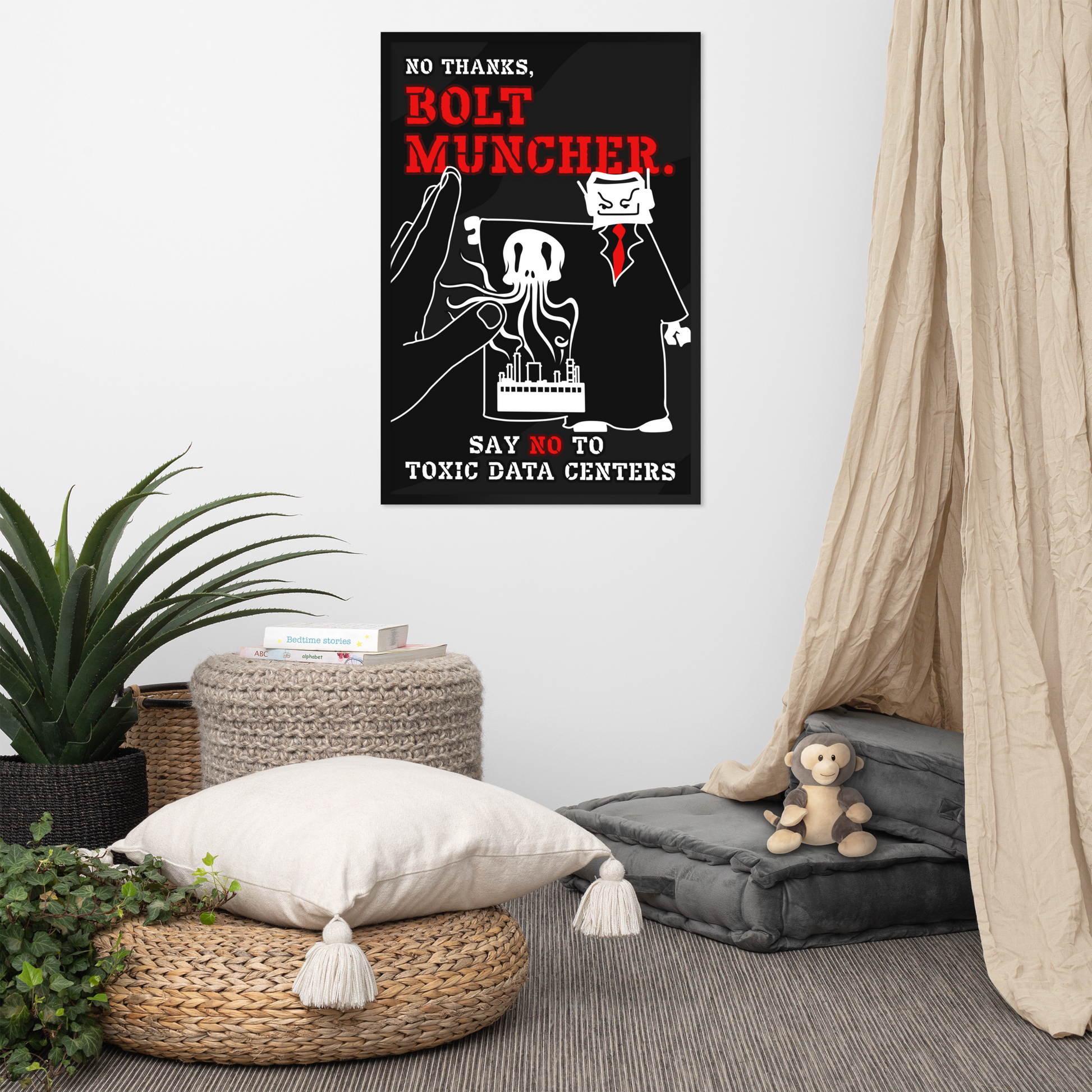 A framed black-and-white protest-style poster with bold red text reading 'NO THANKS, BOLT MUNCHER, SAY NO TO TOXIC DATA CENTERS' hangs on a light wall in a styled room with a beige curtain, woven ottomans, a potted plant, and a small stuffed monkey.