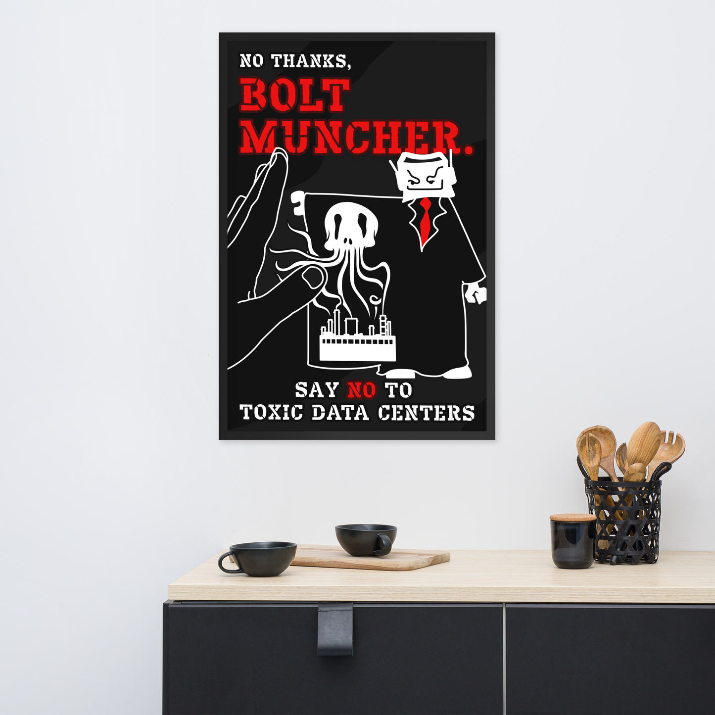 A framed black-and-white protest-style poster with bold red text reading 'BOLT MUNCHER.' hangs on a light gray wall above a kitchen counter with cups and utensils.