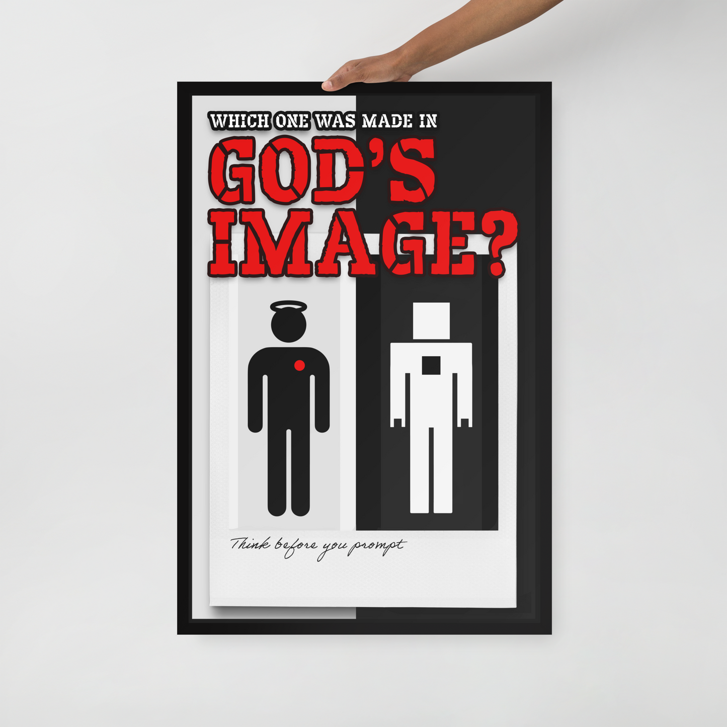 A framed poster with a minimalist black-and-white design and large red text reading 'GOD'S IMAGE?' is being held by a person's hand against a light gray wall. The poster also includes the text 'WHICH ONE WAS MADE IN' and 'Think before you prompt' with simple human figures.