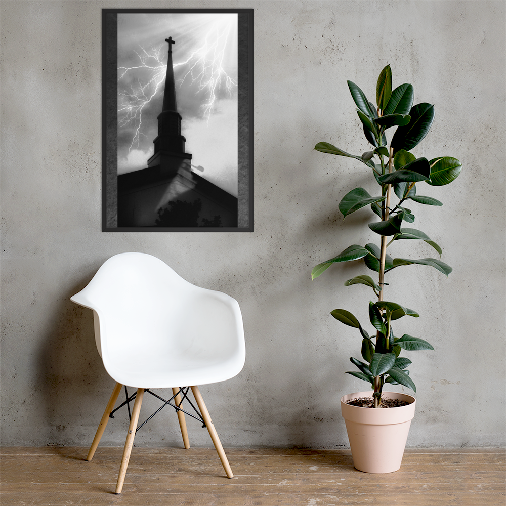 24x36 poster of a shadowy church in front of a lightning strike in grainy black and white heavy metal style leaning on a concrete wall over a chair and a houseplant