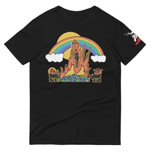Black t-shirt with colorful graphic design featuring a rainbow over a witch being burned at the stake by cute little cartoon dogs